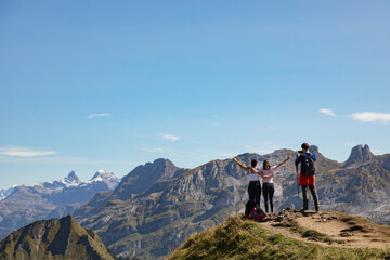Hikers in the mountains contemplating the view, Stoos, Schwyz, Switzerland
