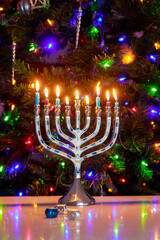 Background with Hanukkah menorah and burning candles for Jewish holiday Hanukkah.