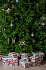 It's Christmas time and there are many beautiful gift boxes under the tree.