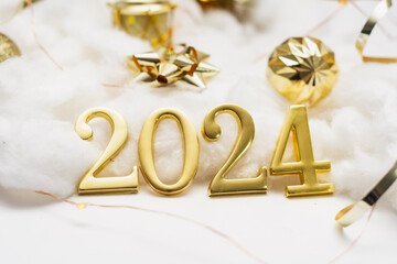 New Year holiday background. Golden numbers 2024 with ribbons and decoration.