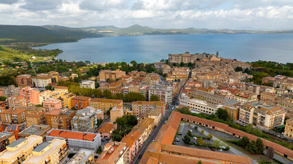 Fototapeta na wymiar Aerial view of Bracciano, in the metropolitan city of Rome, Italy. The town is located on the shores of Lake Bracciano. In the historic center there is the castle and cathedral of Santo Stefano.