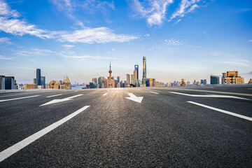 Fototapeta na wymiar Asphalt road and city buildings skyline background in Shanghai