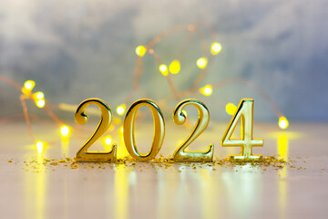New Year holiday background. Golden numbers 2024 with bright glowing lights.