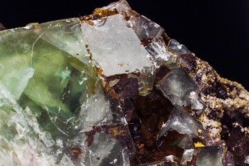 Rough mineral close up on black background. Green fluorite in host rock. Gemstone background,...