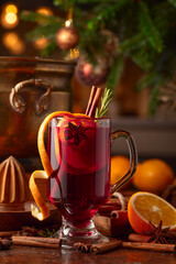Christmas mulled wine with spices, citrus, and vintage kitchen utensils.