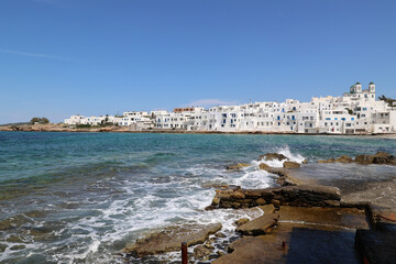White houses on the coast of Naoussa a small port town in the north of the Greek Cyclades island of...