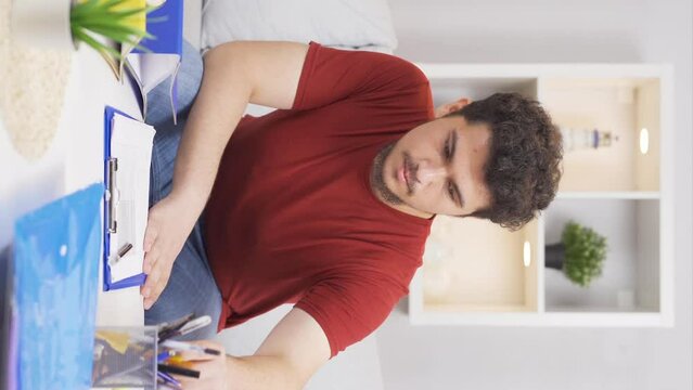 Vertical video of Home office worker man falling from chair.
