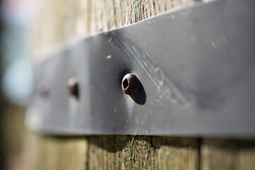 metal strap with Robertson or square headed screw on a wooden object