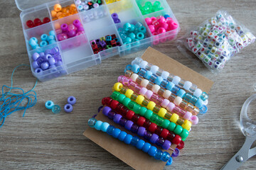 Close-up of a decorative bracelet of colorful beads - obrazy, fototapety, plakaty