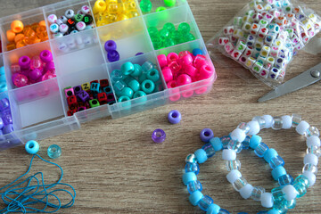 Close-up of a decorative bracelet of colorful beads - obrazy, fototapety, plakaty