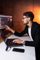 Programmer are coding on a laptop in the dark. The concept of a developer or hacker.