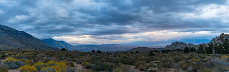 Cloudy morning in the Buttermilks, at the foothills of the Sierra Nevada Mountains in Bishop California. Fall colors and snow capped mountains with large clouds.