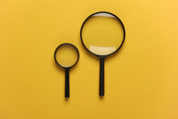 Magnifiers on yellow background. Top view