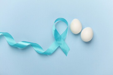 Blue ribbon symbolizing support of men and eggs. Blue november prostate cancer awareness month