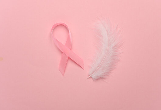 Pink ribbon, breast cancer awareness symbol and feather