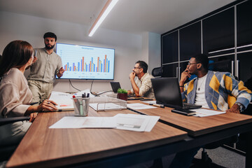 Global Collaboration: Multiracial Team Brainstorming Profitable Sales Strategy in Modern Board Room