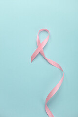 Pink ribbon, breast cancer awareness symbol on blue background. Women Health