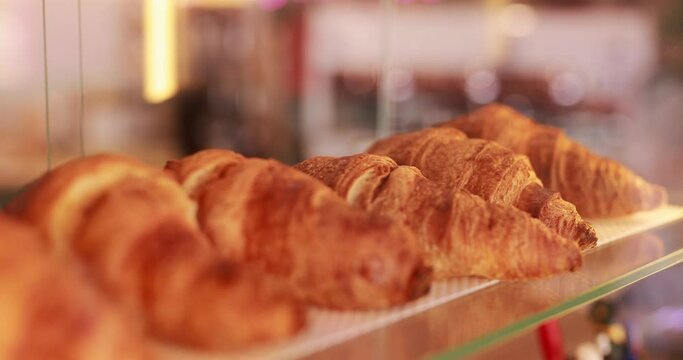 A row of croissants on showcase in a cafe