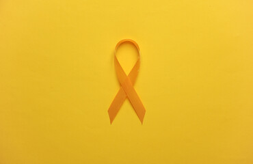 Yellow ribbon, childhood cancer awareness day symbol - obrazy, fototapety, plakaty