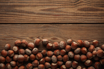 Hazelnuts on a wooden table. Top view. Copy space