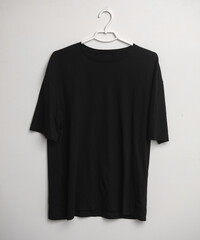 Black t-shirt mockup with hanger on white background