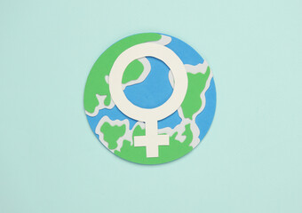 World Women's Day. Feminism. Female gender symbol and globe on blue background