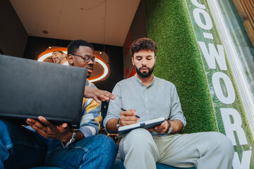 Confident professionals collaborate in a diverse co-working space, driving growth and success through persistent teamwork and innovative solutions in a modern workspace.