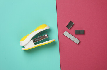 Yellow Stapler with bullets starting on pink blue background