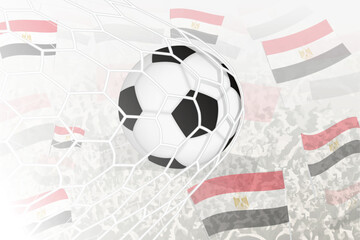 National Football team of Egypt scored goal. Ball in goal net, while football supporters are waving the Egypt flag in the background.