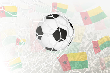 National Football team of Guinea-Bissau scored goal. Ball in goal net, while football supporters are waving the Guinea-Bissau flag in the background.
