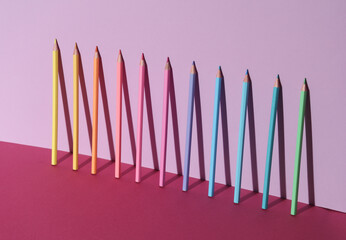 Set of colored pencils on pink background with shadow. Creative layout © splitov27