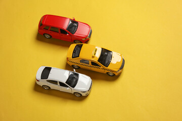 Car and taxi models on yellow background. Travel, vocation concept