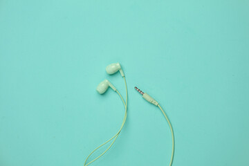 Wired earphones on a blue background