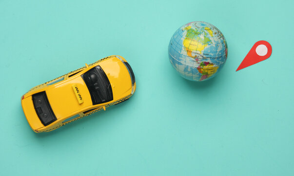 Taxi Car model with geolocation point sign and globe on blue background. Navigation, travel concept. Flat lay - Powered by Adobe