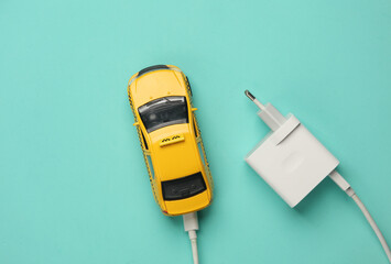 Taxi car with charger on blue background. Modern technologies, electric car