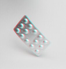 Metal blister pills flying in antigravity on blue background with shadow. Levitation object in the air. Medicine croncept. Creative minimal layout. Glitch, vhs effect