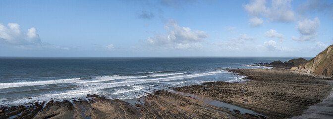 View of the dramatic rocks and seascape at Speke's Mill Mouth Beach, in Hartland, North Devon, UK.