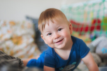 Fototapeta premium Portrait of cute happy baby boy looking at camera. Joy and happiness concept. Love and family emotion