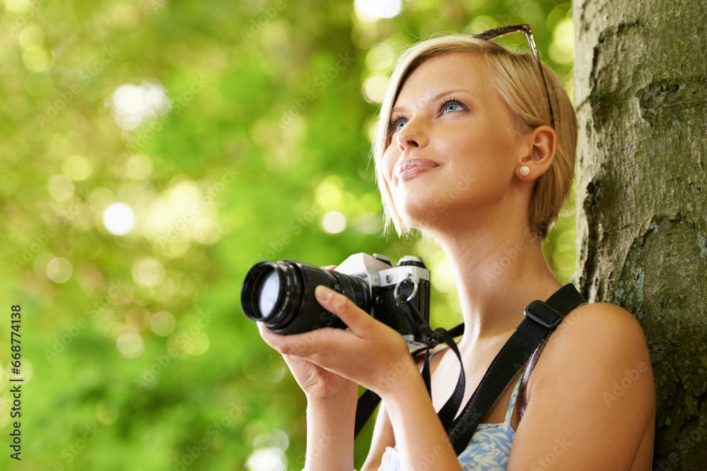 Wall mural Happy, woman and photographer in nature with trees, camera and vacation in environment. Forest, park and girl filming with natural happiness outdoor on summer holiday, trip or travel with technology