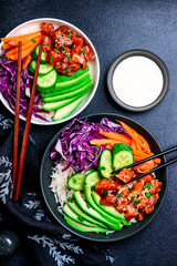 Salmon poke bowl with vegetables and avocado.top veiw