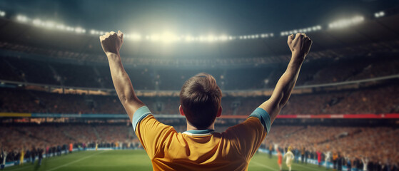 Football fan cheers, hands raised.