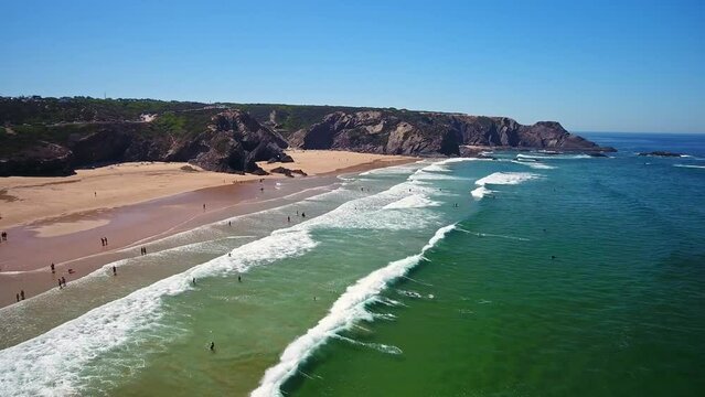 Aerial video filming by drone of sea bay and beach near village of Odeceixe Alentejo Portugal.