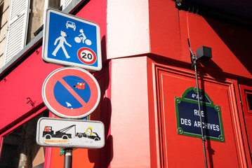 Paris, France. Funny road signs in Marais district. Urban street art.