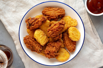 Homemade Chicken Nuggets and Chicken Wings with Ketchup and Beer, top view.