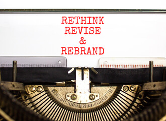 Rethink revise rebrand symbol. Concept word Rethink Revise and Rebrand typed on typewriter. Beautiful white paper background. Business brand motivational rethink revise rebrand concept. Copy space