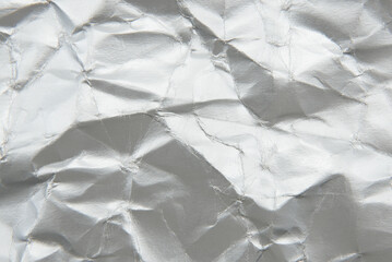 Texture of crumpled silver paper. Background made of crumpled paper with folds