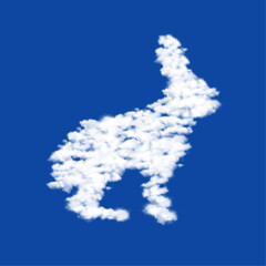 Clouds in the shape of a hare symbol on a blue sky background. A symbol consisting of clouds in the center. Vector illustration on blue background