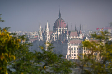 Fototapeta na wymiar Hungarian Parliament building. View from above over the Budapest Parliament landmark construction, next to Danube river, during a foggy summer morning. Travel to Hungary.