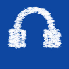 Clouds in the shape of a headphones symbol on a blue sky background. A symbol consisting of clouds in the center. Vector illustration on blue background