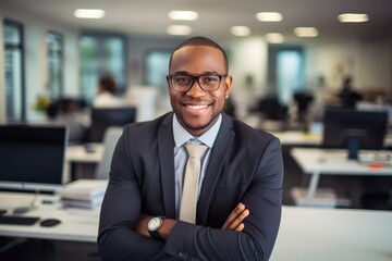 Fototapeta premium Photo, handsome cheerful African American businessman at his workplace in a spacious bright office